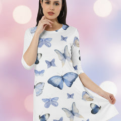 Woman wearing a white dress with blue butterfly patterns on a white background
