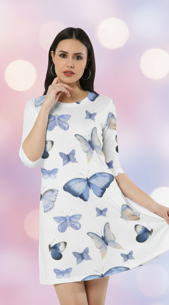 Woman wearing a white dress with blue butterfly patterns on a white background