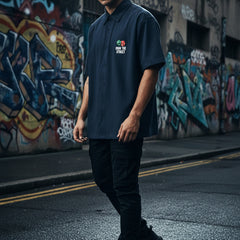 Blue  shirt with graphic design and text on a white background