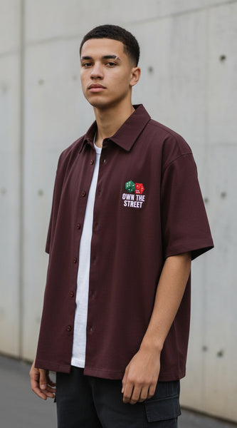 Maroon shirt with graphic design and text on a white background