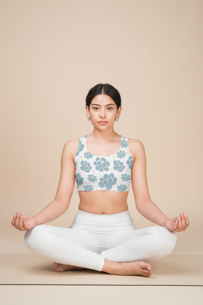 Woman wearing a floral-patterned sports bra on a white background