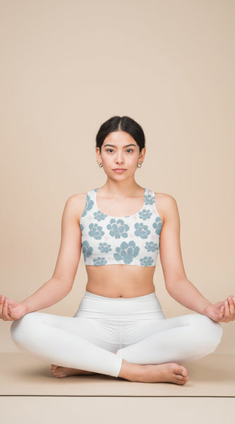 Woman wearing a floral-patterned sports bra on a white background