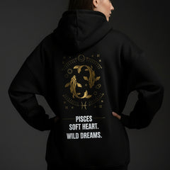 Black hoodie with gold and white text and graphics on a light gray background