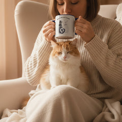 Two mugs with a cat illustration and text on a pink background