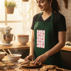 Woman wearing a green apron with a red and white pattern on a white background