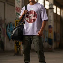 Light purple t-shirt with 'Strength Over Excuses' graphic on a white background
