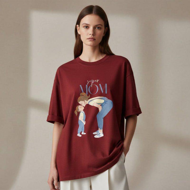 Woman wearing a Red  t-shirt with a graphic design and text on a plain background