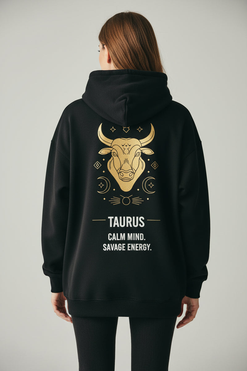 Black hoodie with Taurus zodiac design on the back against a white background