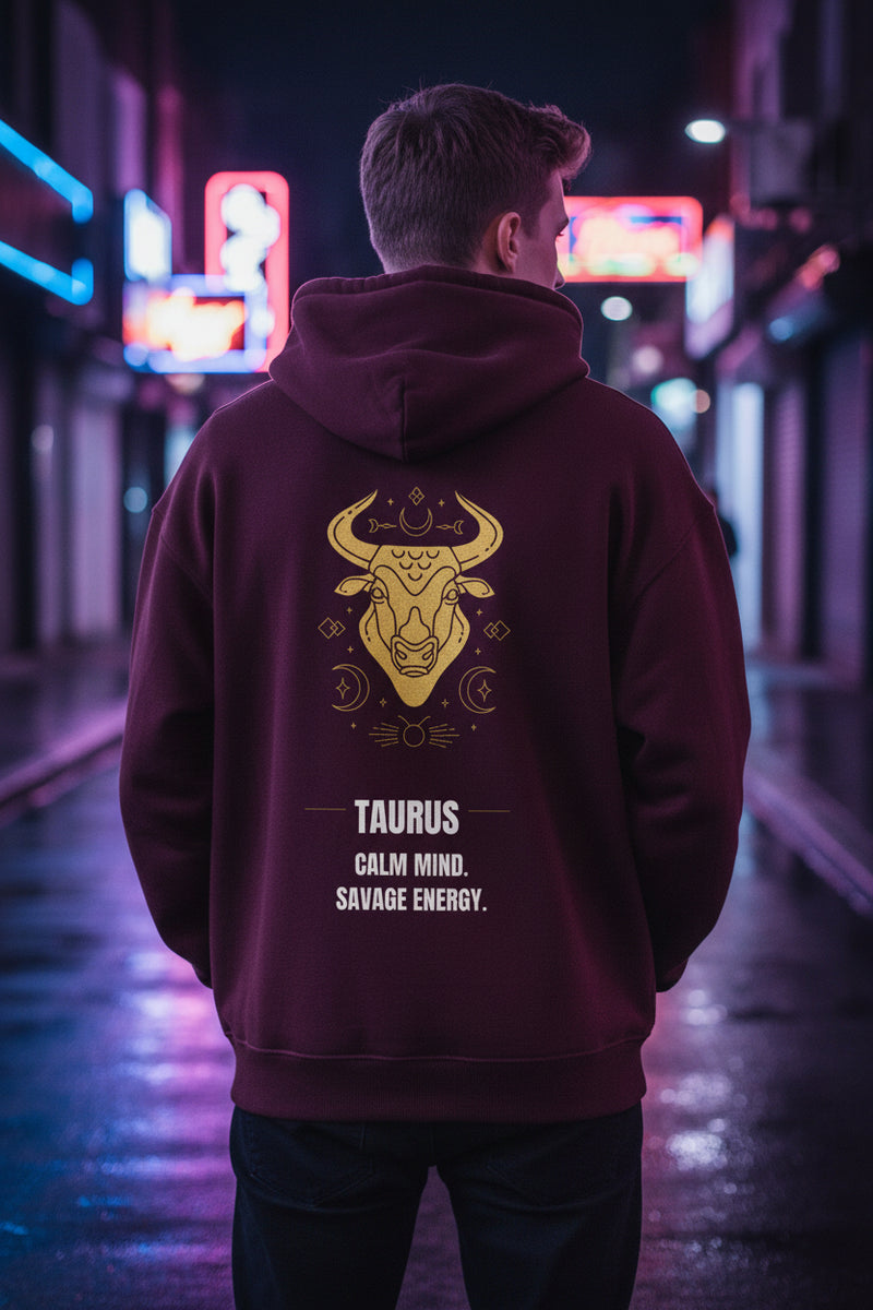 Maroon hoodie with gold Taurus design and text on a white background