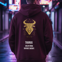 Maroon hoodie with gold Taurus design and text on a white background