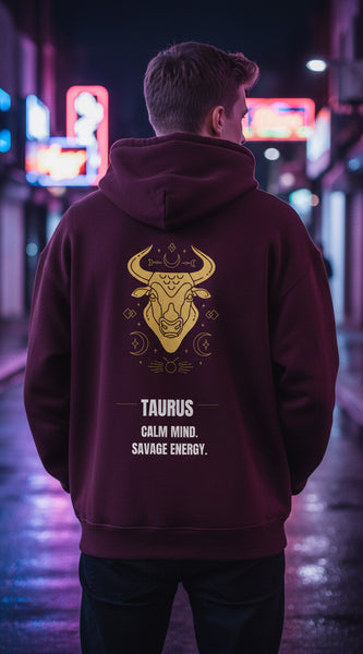 Maroon hoodie with gold Taurus design and text on a white background