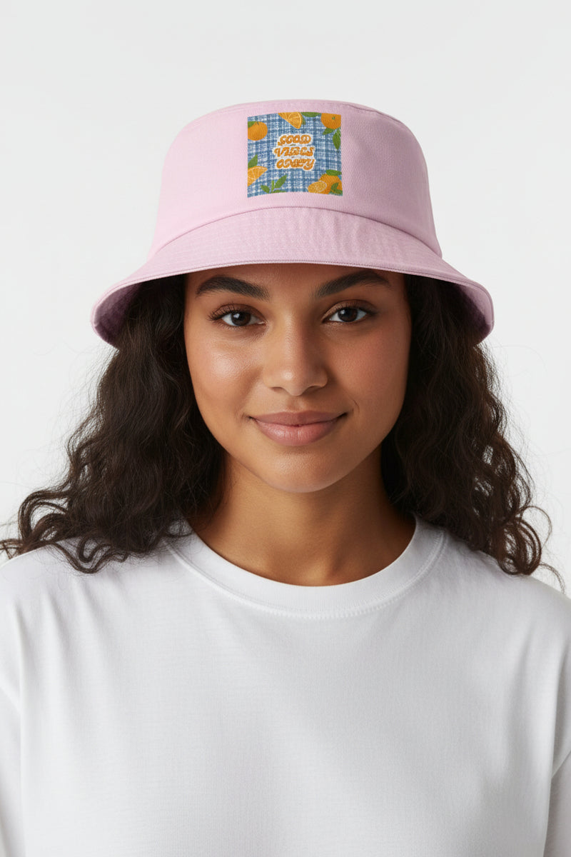 Pink bucket hat with a colorful patch on a white background
