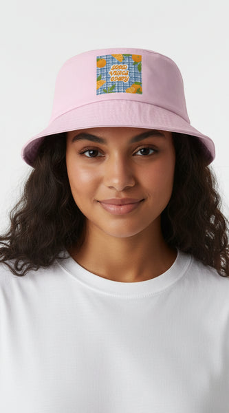 Pink bucket hat with a colorful patch on a white background