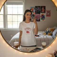 Woman wearing a white t-shirt with a graphic design and text