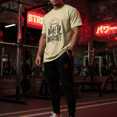 Beige t-shirt with 'Wake Up Workout' text and graphic on a white background
