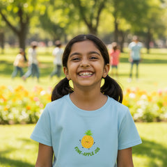 White t-shirt with a pineapple graphic and text on a white background