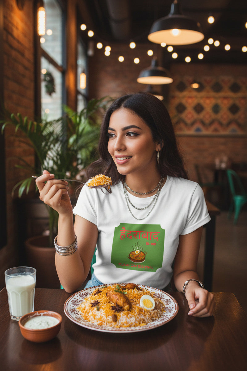 White t-shirt with a green label featuring text and an image of food on a white background