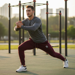Maroon sweatpants with a small logo on a white background